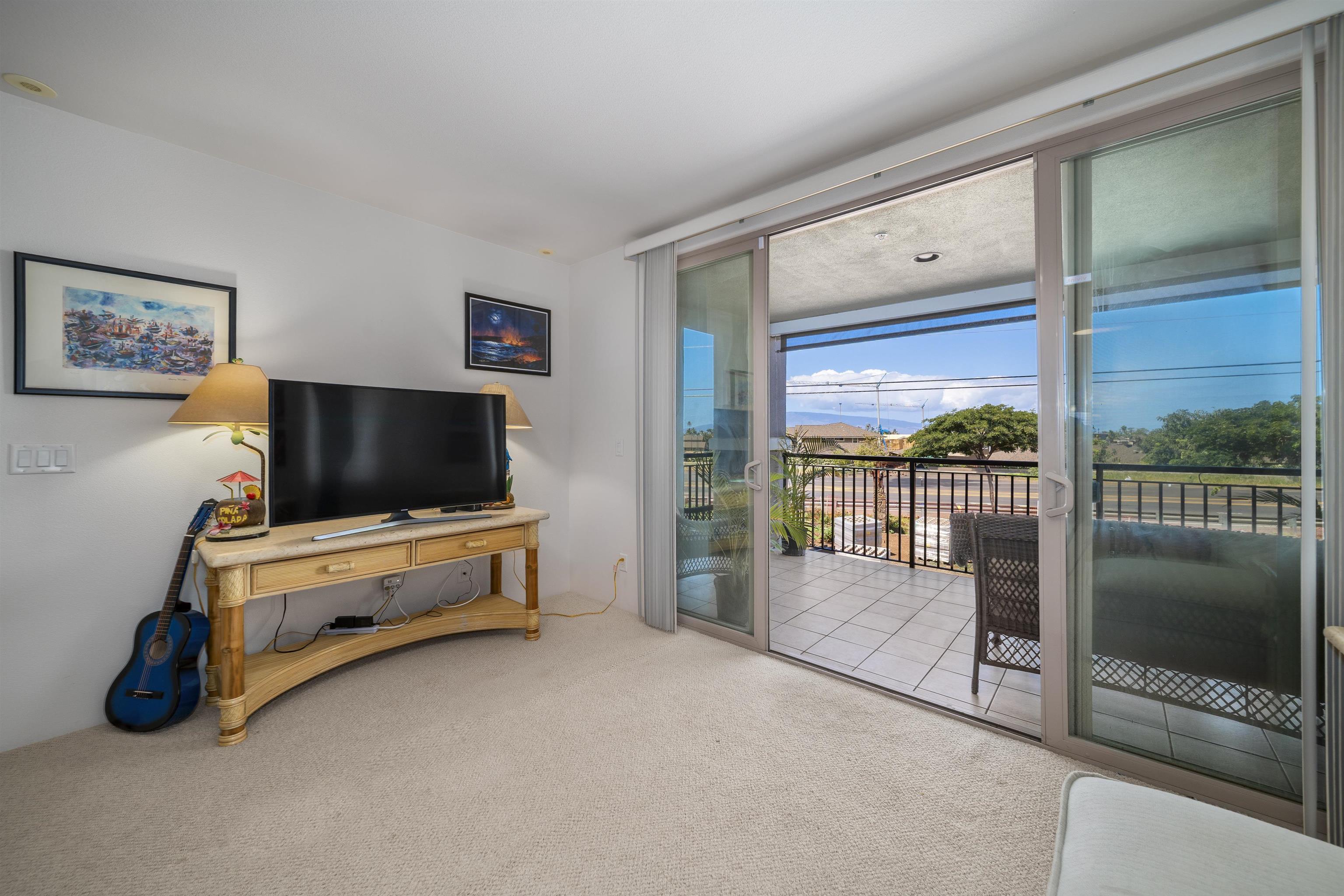 1233 Limahana Circle, Unit B202 Lahaina, HI 96761 - Photo 17 of 30 a living room with furniture and a flat screen tv