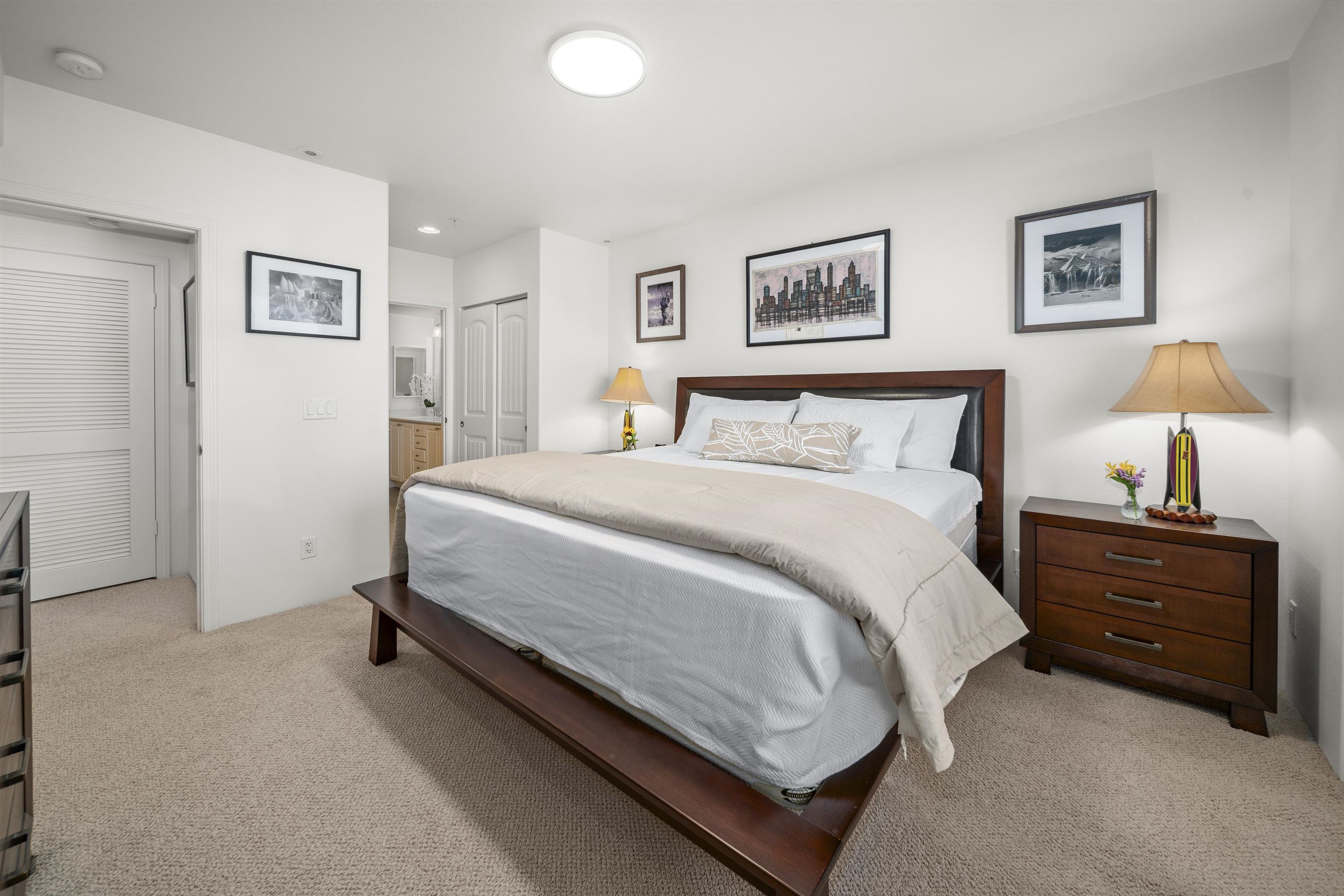 1233 Limahana Circle, Unit B202 Lahaina, HI 96761 - Photo 18 of 30 a spacious bedroom with a bed and a lamp