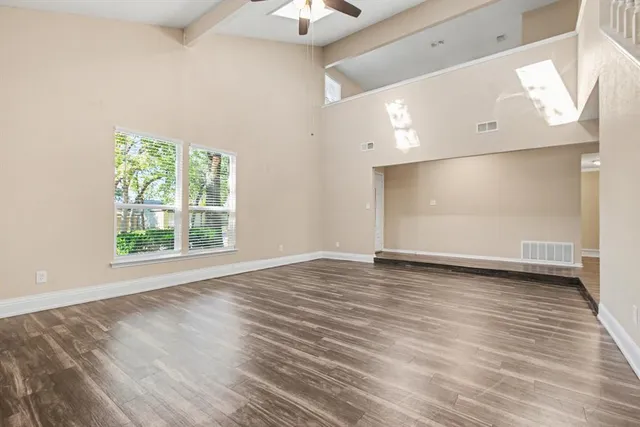 wooden floor in an empty room with a window
