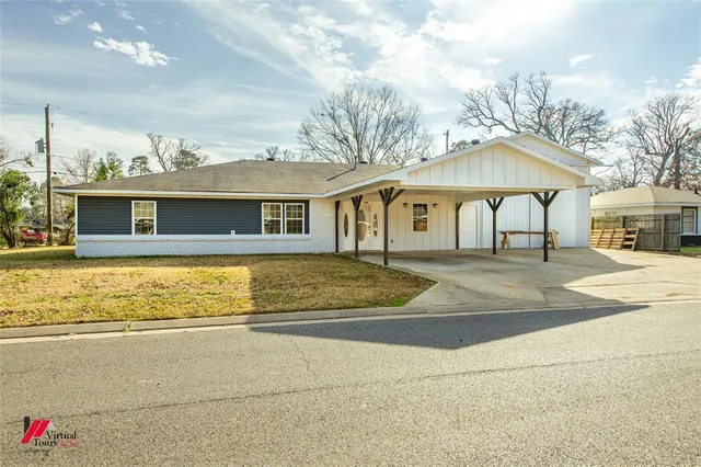 a view of a white house with a swimming pool