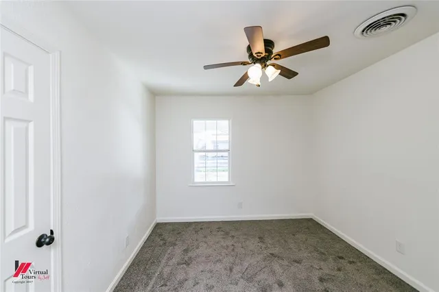 a view of a ceiling fan and hardwood floor