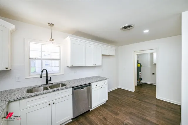 a kitchen with sink and cabinets