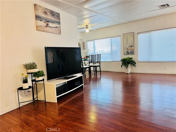 a view of a dining room with furniture and wooden floor