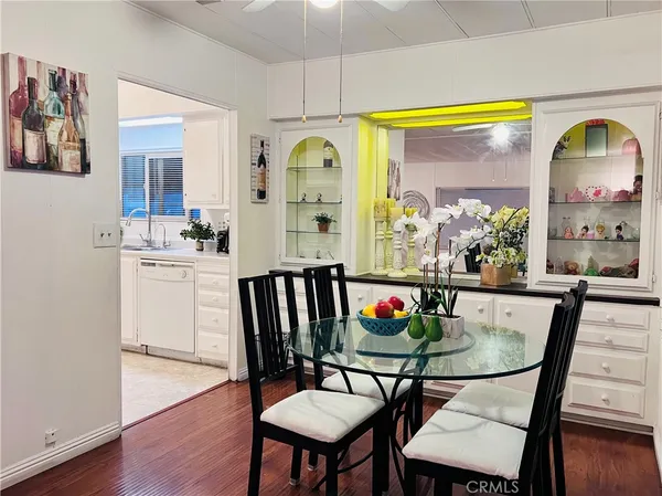 a large white kitchen with lots of counter space a sink and appliances