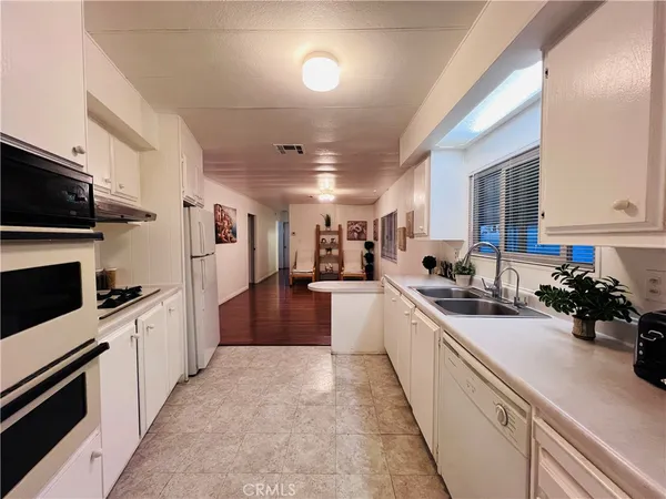 a kitchen with stainless steel appliances a stove and a refrigerator