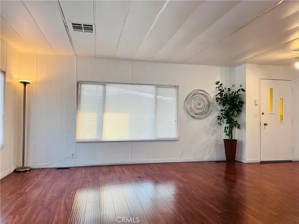 a view of kitchen with furniture and wooden floor
