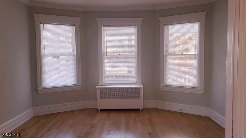 16 Munn Street, Unit 1 Montclair, NJ 07042 - Photo 2 of 22 an empty room with wooden floor and windows