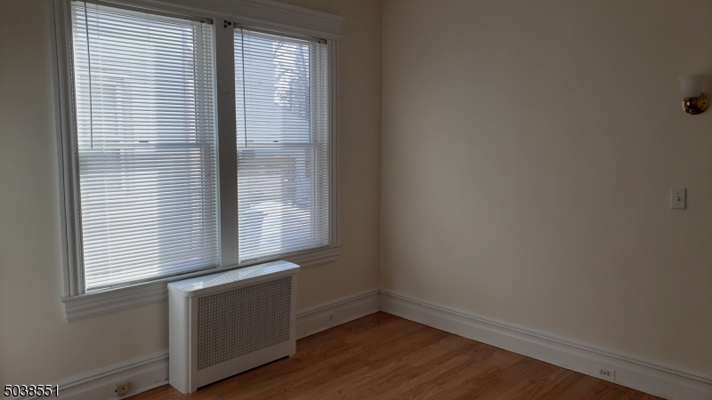 16 Munn Street, Unit 1 Montclair, NJ 07042 - Photo 15 of 22 a view of an empty room with wooden floor and a window