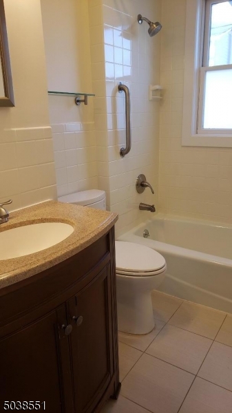 16 Munn Street, Unit 1 Montclair, NJ 07042 - Photo 17 of 22 a bathroom with a sink a toilet and shower