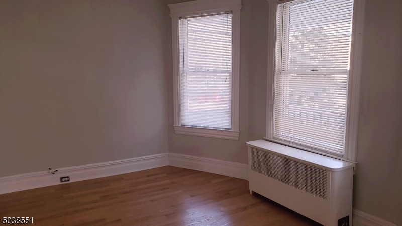 16 Munn Street, Unit 1 Montclair, NJ 07042 - Photo 3 of 22 a view of an empty room with wooden floor and a window