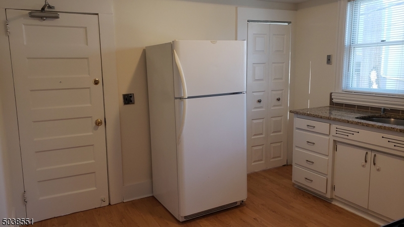 16 Munn Street, Unit 1 Montclair, NJ 07042 - Photo 8 of 22 a white refrigerator freezer and a stove sitting inside of a kitchen