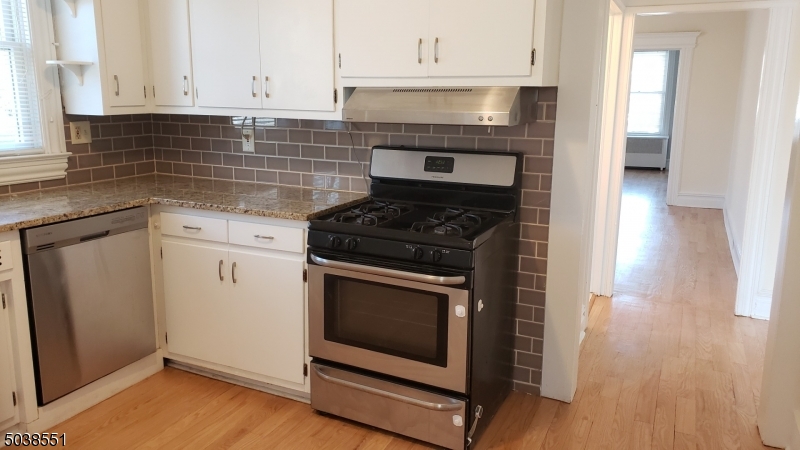 16 Munn Street, Unit 1 Montclair, NJ 07042 - Photo 9 of 22 a kitchen with granite countertop white cabinets and appliances
