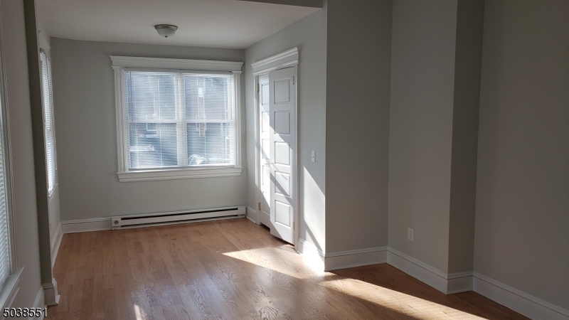 16 Munn Street, Unit 1 Montclair, NJ 07042 - Photo 10 of 22 an empty room with wooden floor and windows