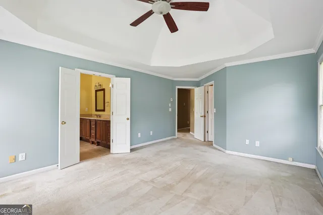a view of empty room with ceiling fan