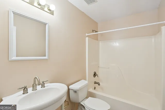 a bathroom with a toilet a sink and a shower