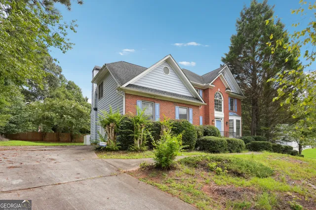 a front view of a house with garden