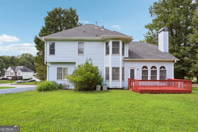a front view of a house with a yard table and chairs