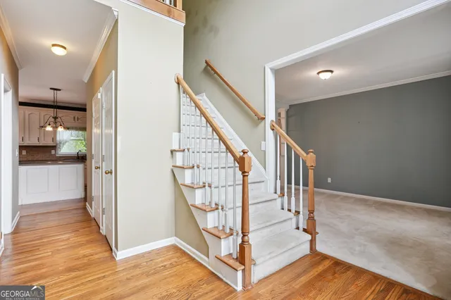 a view of entryway with wooden floor and stairs
