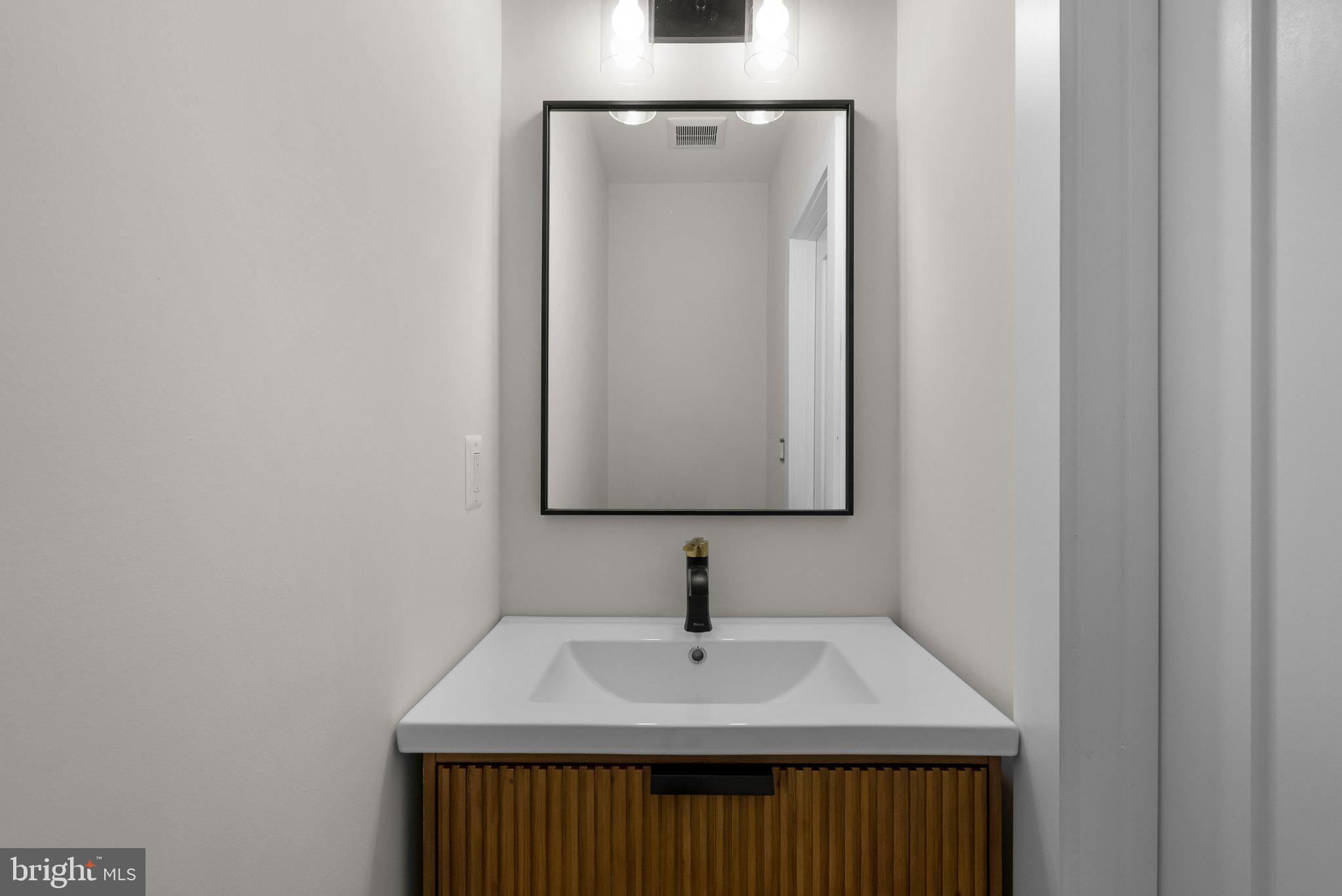 3710 S Street Northwest Washington, DC 20007 - Photo 11 of 32 a bathroom with a sink and a mirror