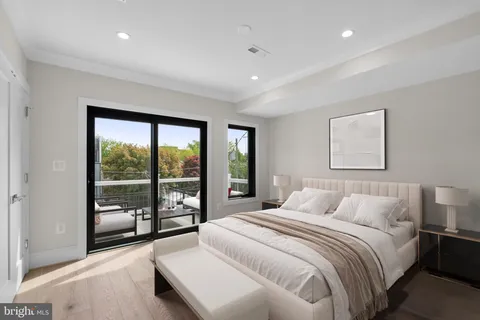 a bedroom with a large bed and a large window