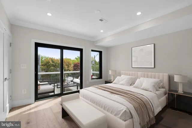 a bedroom with a large bed and a large window