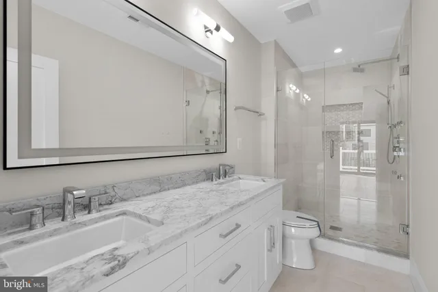 a bathroom with a granite countertop sink mirror and double