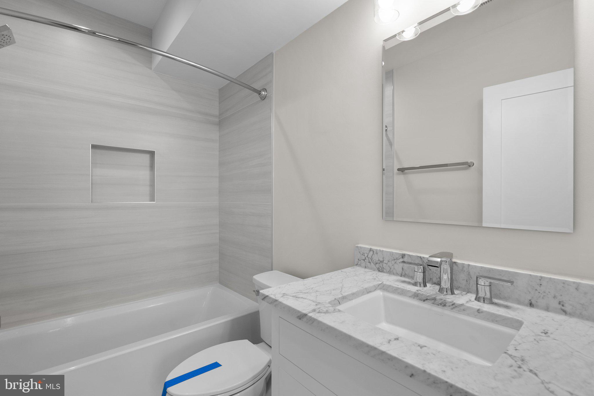 3710 S Street Northwest Washington, DC 20007 - Photo 18 of 32 a bathroom with a granite countertop sink a toilet and shower