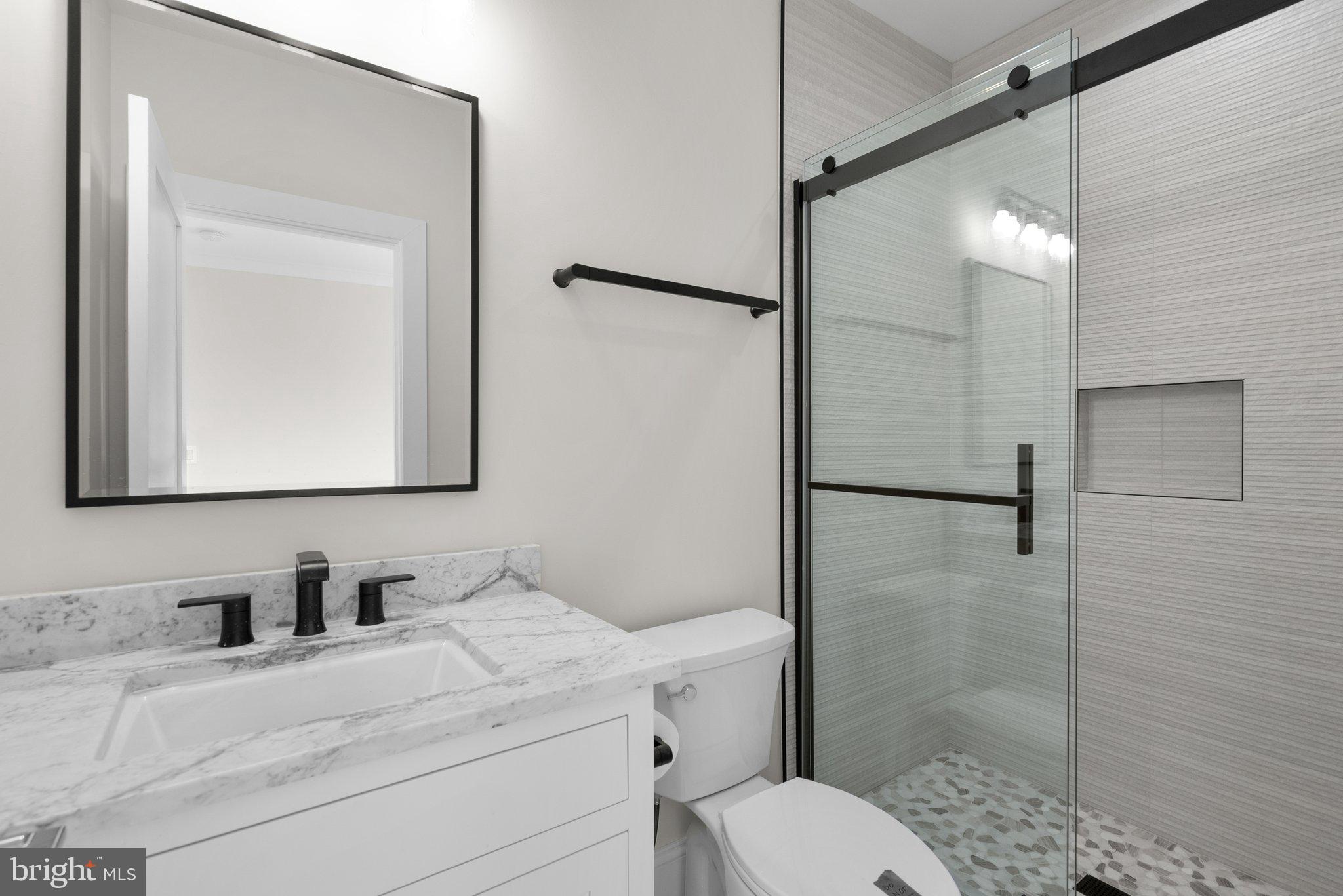 3710 S Street Northwest Washington, DC 20007 - Photo 21 of 32 a bathroom with a granite countertop sink toilet and shower