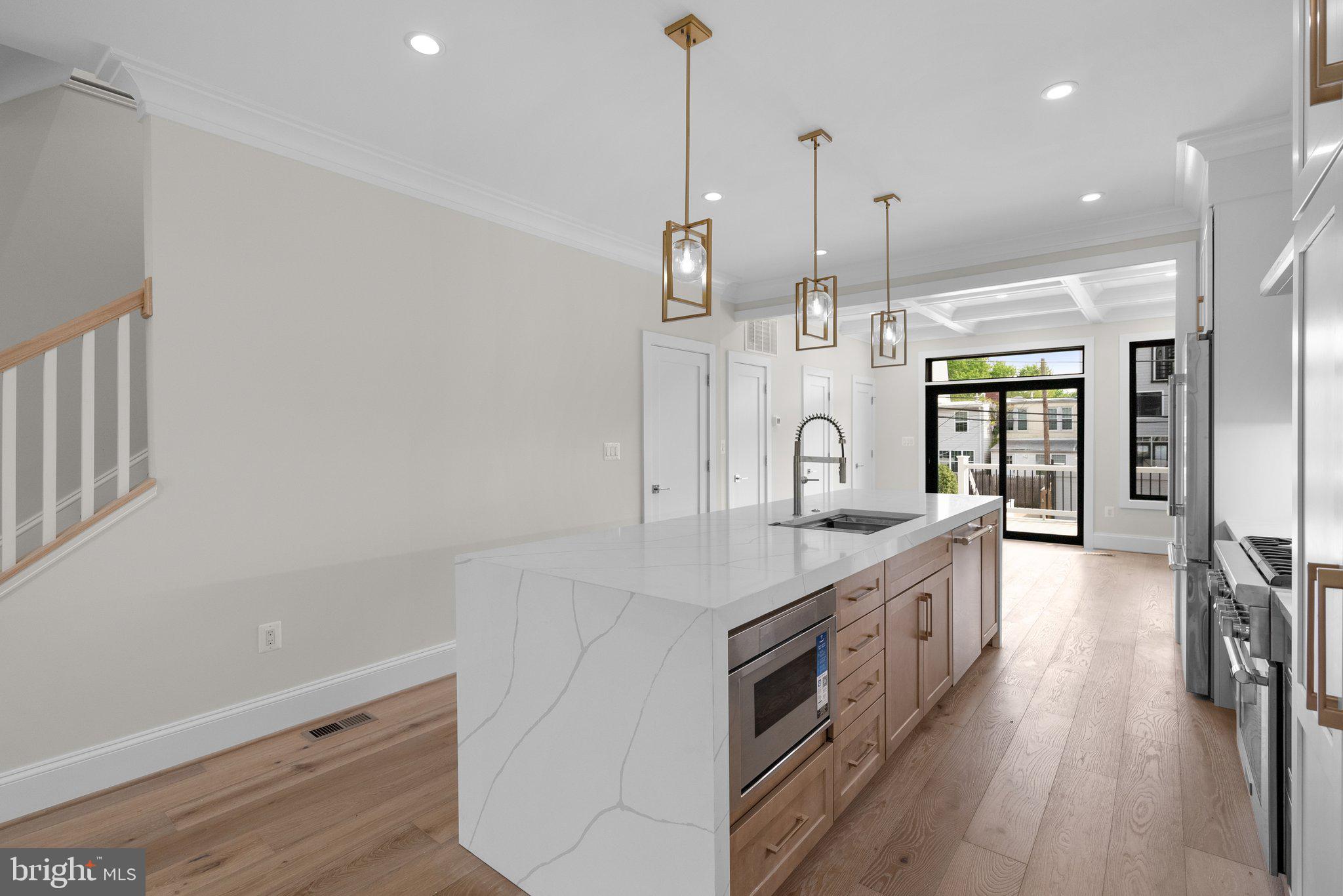 3710 S Street Northwest Washington, DC 20007 - Photo 4 of 32 a kitchen with stainless steel appliances granite countertop a sink and a wooden floor