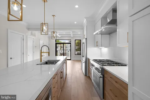a kitchen with stainless steel appliances granite countertop a sink stove and cabinets