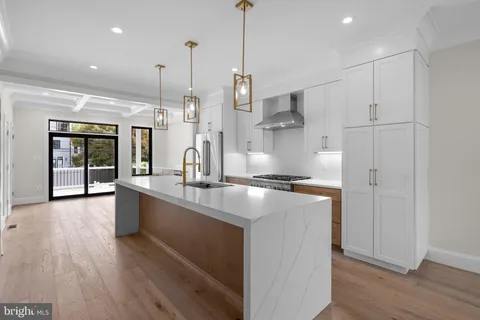 a kitchen with counter top space and wooden floor