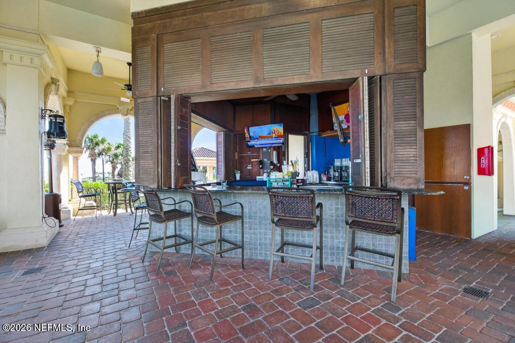 320 Ocean Crest Drive Palm Coast, FL 32137 - Photo 55 of 93 a group of chairs sitting in front of a building