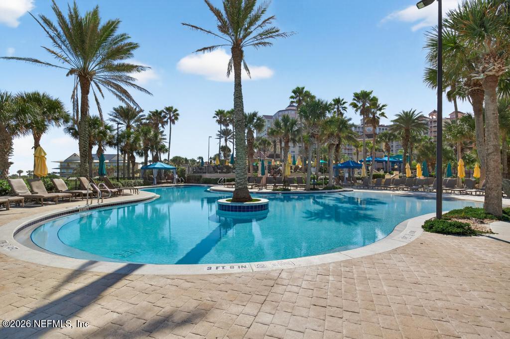 320 Ocean Crest Drive Palm Coast, FL 32137 - Photo 62 of 93 a view of a swimming pool with a sitting area