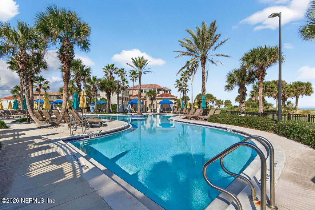320 Ocean Crest Drive Palm Coast, FL 32137 - Photo 64 of 93 a view of swimming pool with outdoor seating and plants