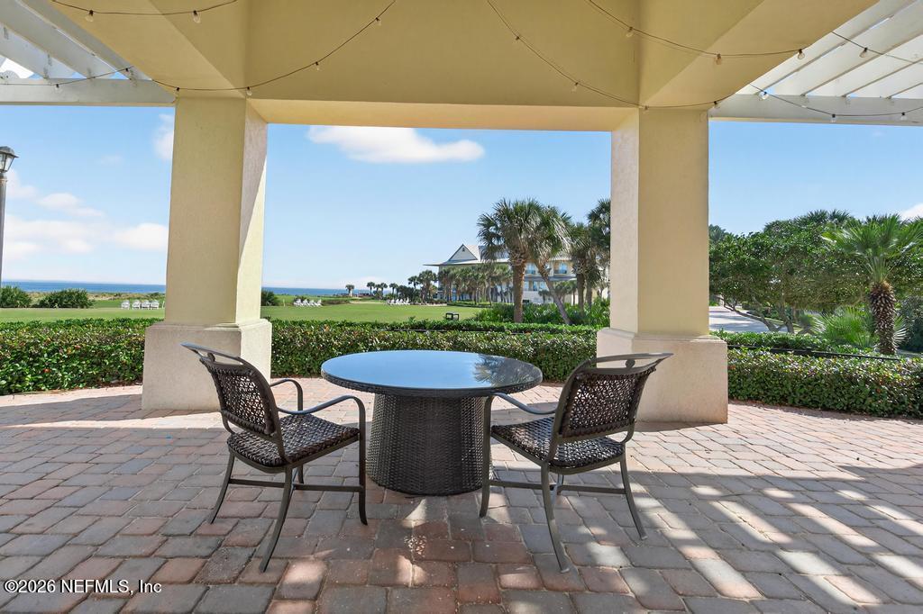 320 Ocean Crest Drive Palm Coast, FL 32137 - Photo 66 of 93 a view of a patio with a table and chairs