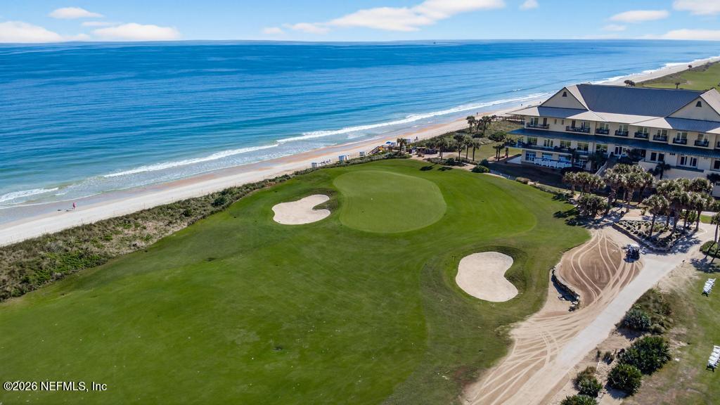 320 Ocean Crest Drive Palm Coast, FL 32137 - Photo 78 of 93 a view of a swimming pool with lawn chairs and potted plants