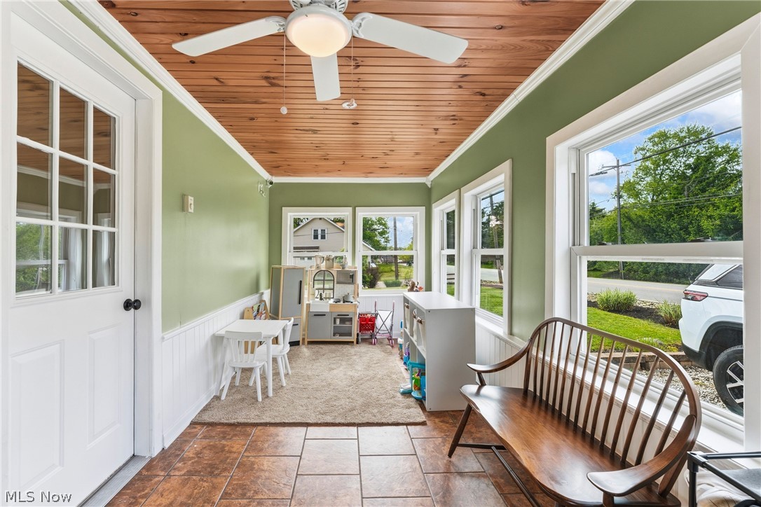 258 Randolph Road Mogadore, OH 44260 - Photo 6 of 49 Sun-drenched room featuring a wood-panel ceiling, ceiling fan, and large windows