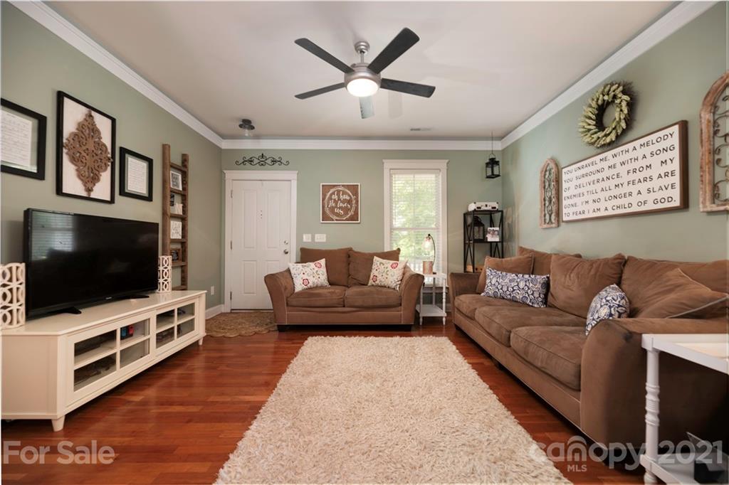 8237 Bud Henderson Road Huntersville, NC 28078 - Photo 11 of 25 a living room with furniture and a flat screen tv