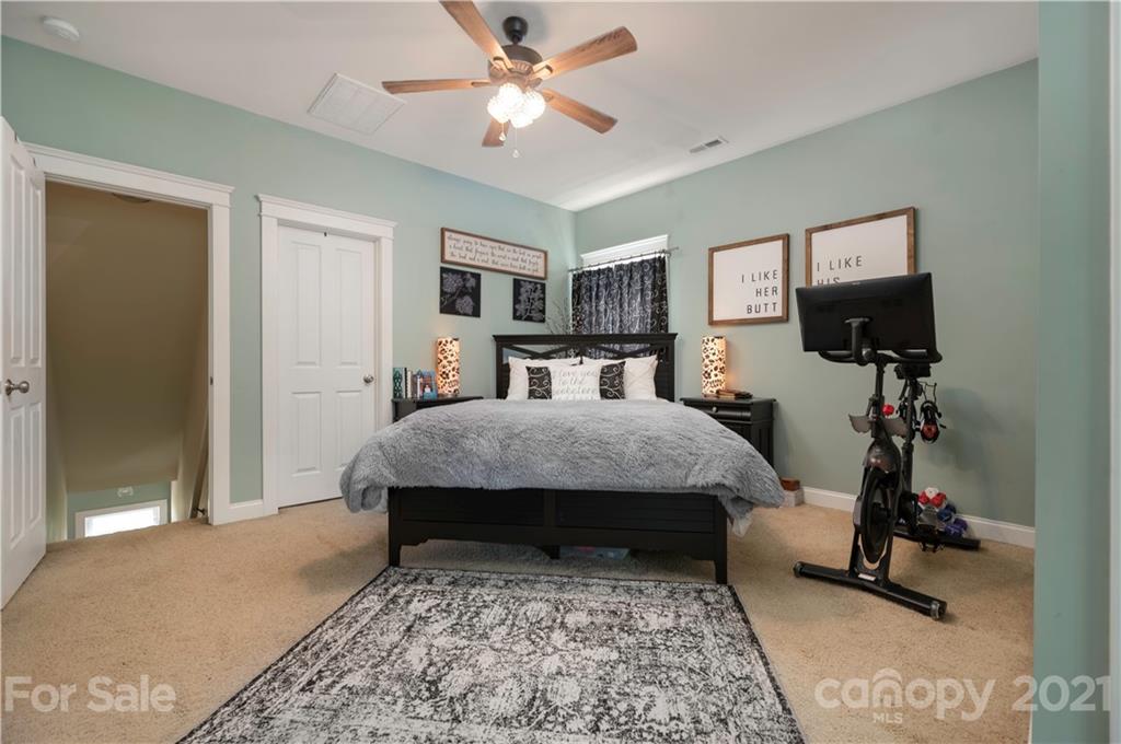 8237 Bud Henderson Road Huntersville, NC 28078 - Photo 12 of 25 a bedroom with a bed and a flat screen tv