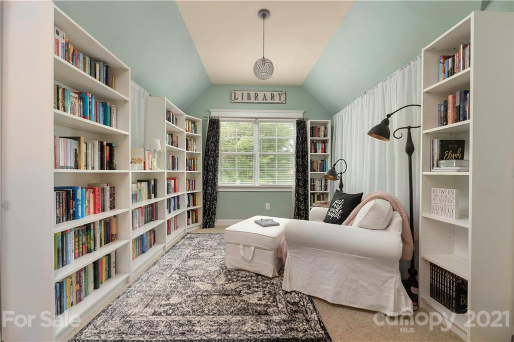8237 Bud Henderson Road Huntersville, NC 28078 - Photo 13 of 25 a living room with a couch and a book shelf