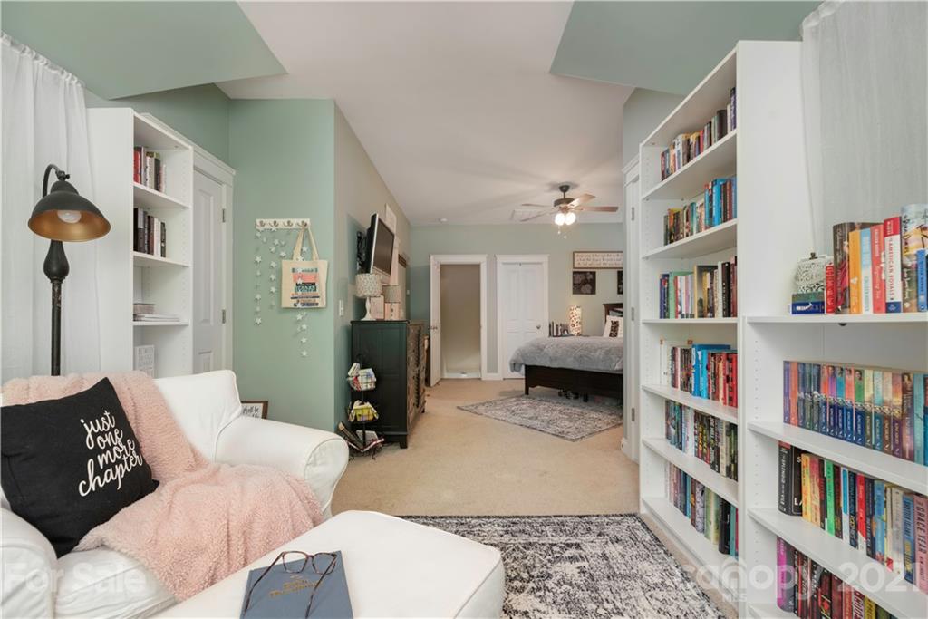 8237 Bud Henderson Road Huntersville, NC 28078 - Photo 14 of 25 a living room with furniture and a book shelf