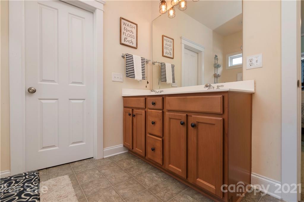 8237 Bud Henderson Road Huntersville, NC 28078 - Photo 16 of 25 a spacious bathroom with a double vanity sink and a mirror