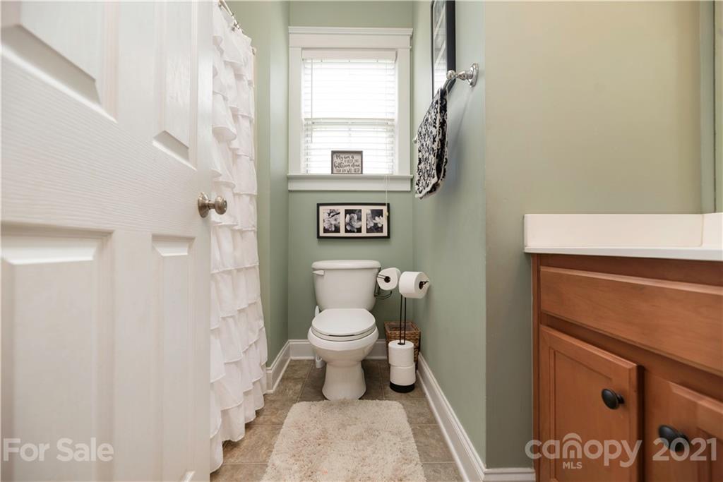 8237 Bud Henderson Road Huntersville, NC 28078 - Photo 17 of 25 a bathroom with a toilet and a shower curtain