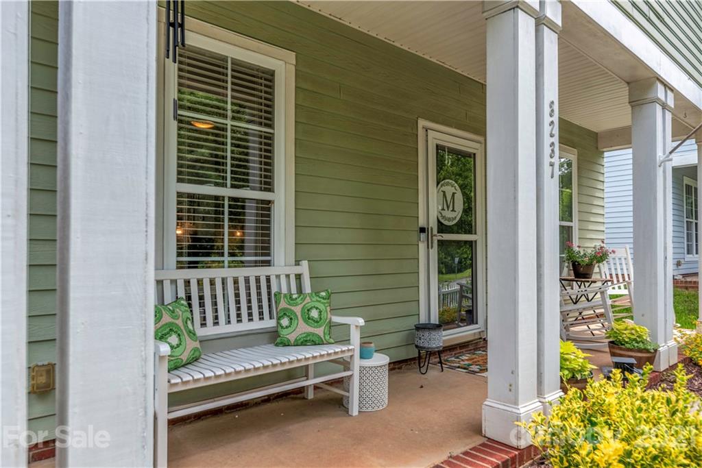 8237 Bud Henderson Road Huntersville, NC 28078 - Photo 5 of 25 a view of a porch with chairs and potted plants