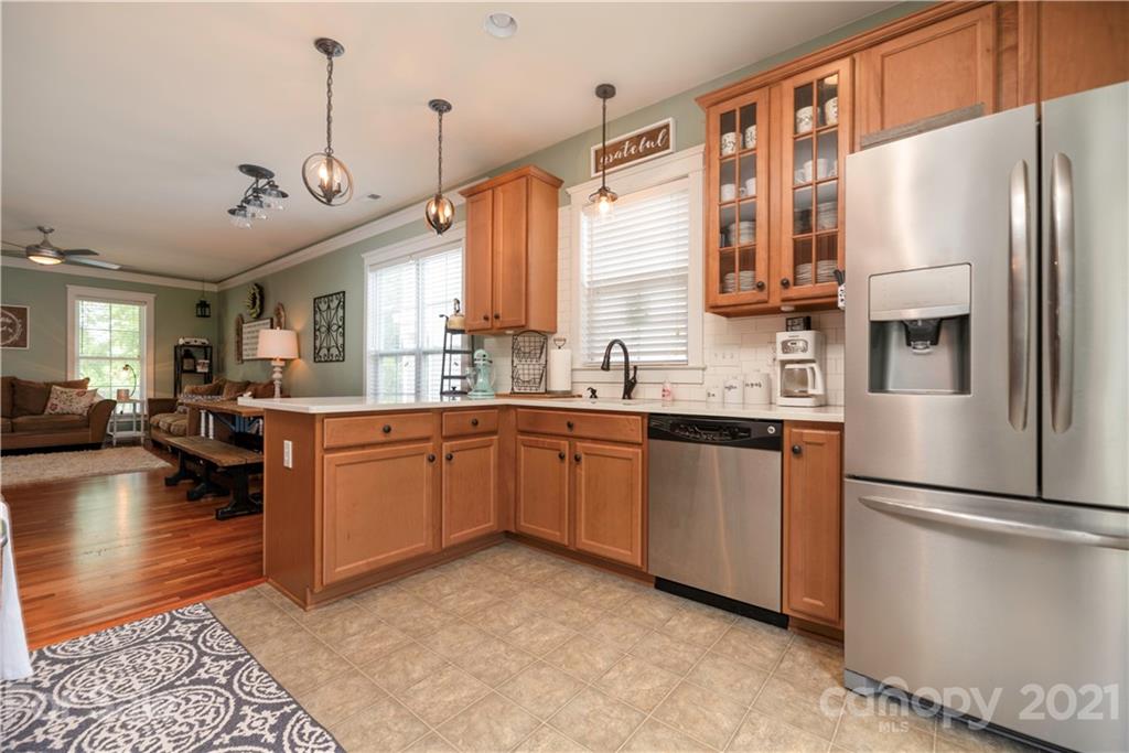 8237 Bud Henderson Road Huntersville, NC 28078 - Photo 6 of 25 a kitchen with a refrigerator and a sink