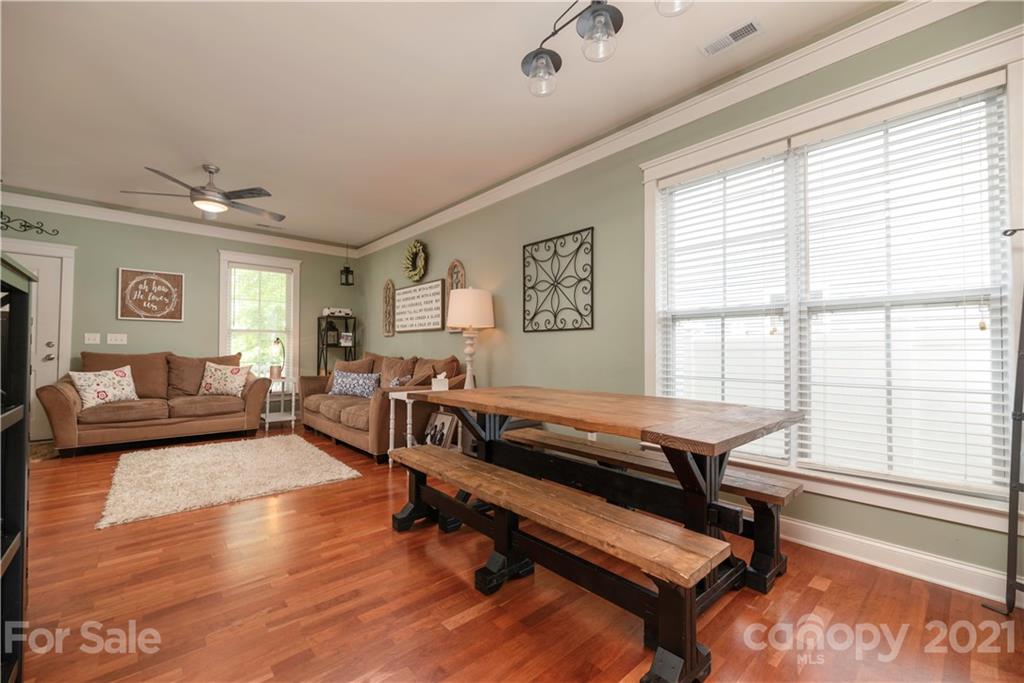 8237 Bud Henderson Road Huntersville, NC 28078 - Photo 9 of 25 a living room with furniture a rug and a large window