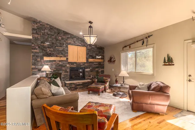 a living room with furniture a fireplace and a chandelier