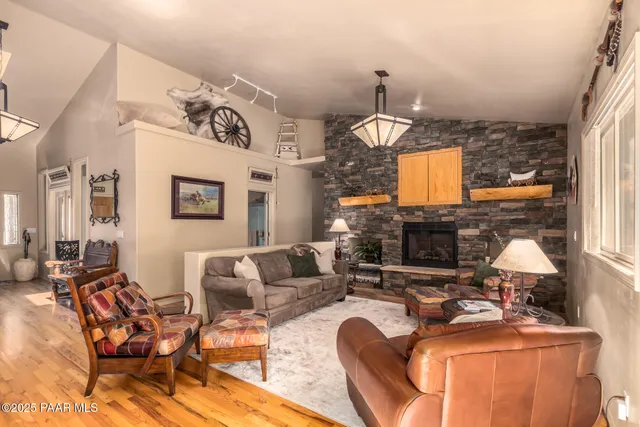 a living room with furniture a fireplace and a chandelier