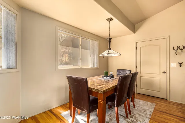 a dining room with furniture and window
