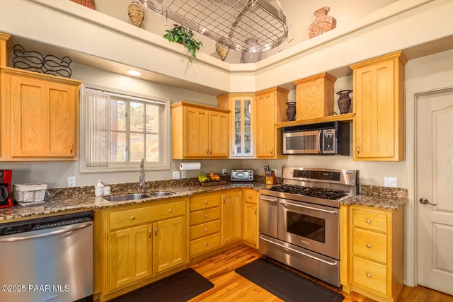 a kitchen with stainless steel appliances a stove sink and cabinets